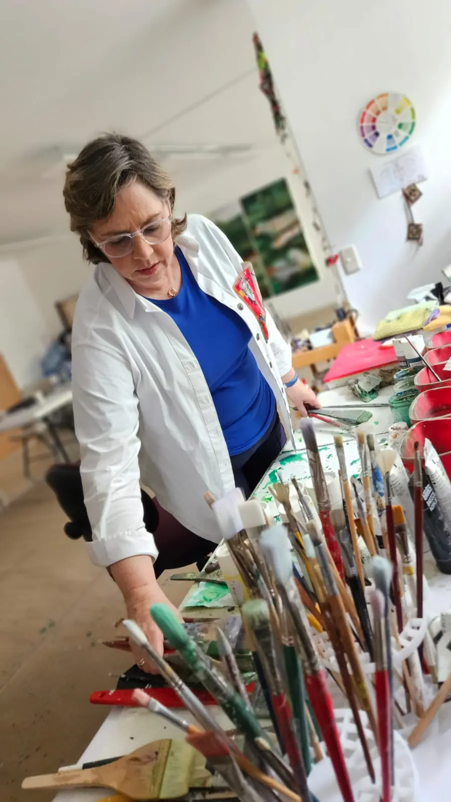 Artist in studio with paintings